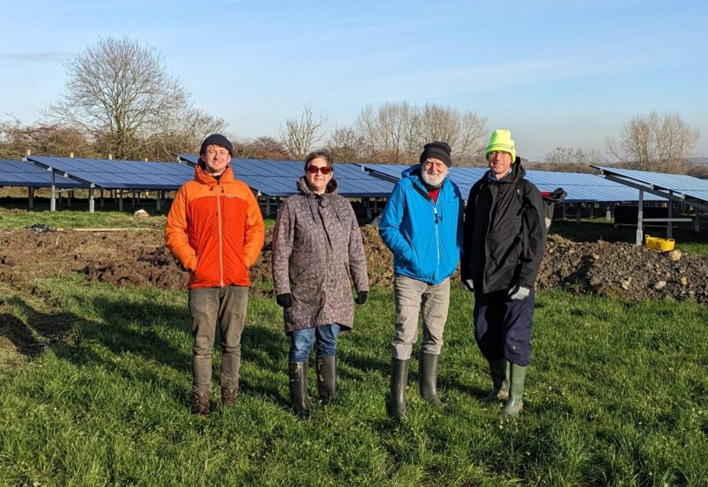 Sharenergy development team with phase 1 solar panels